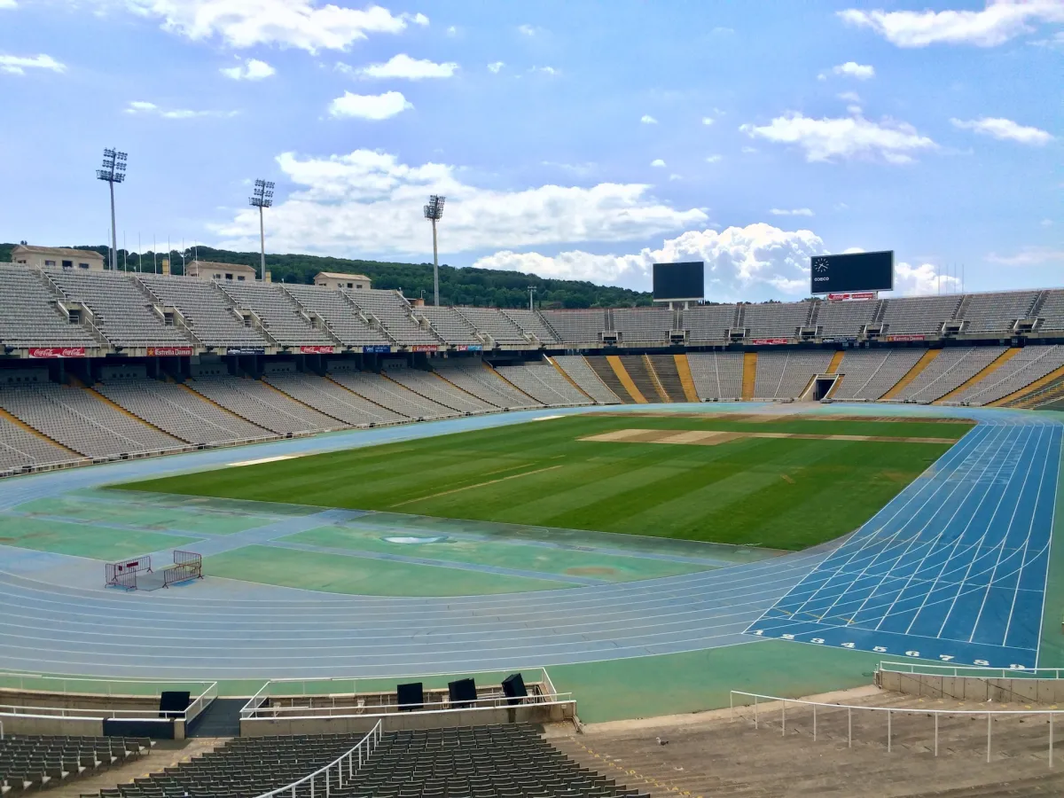 An empty Olympic stadium with a running track around the pitch.