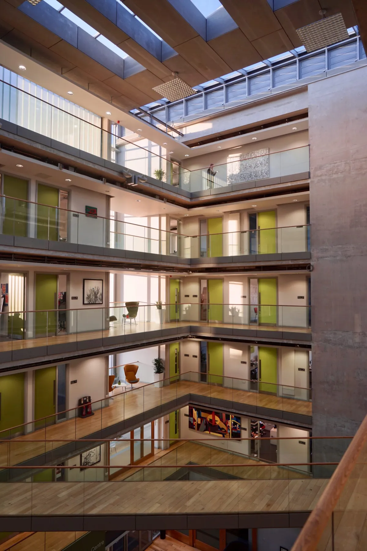 The atrium of an office building, its walkways stacked around a central void.
