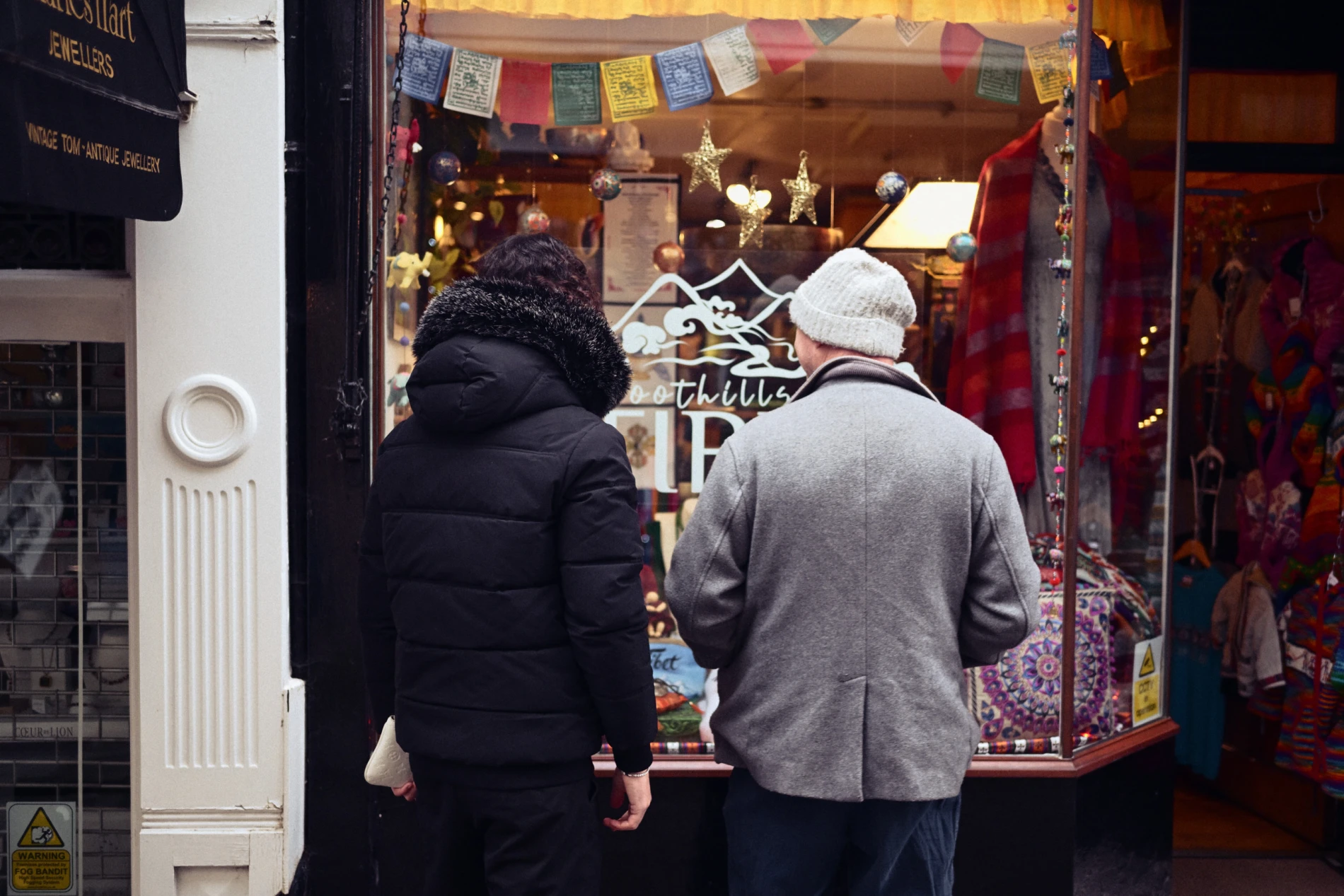 Two men looking through a shop window