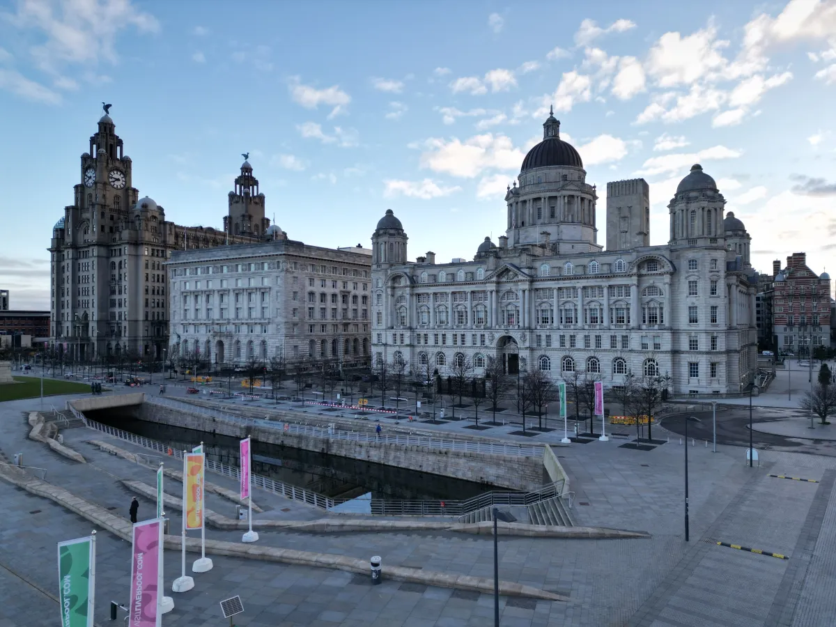 The Royal Liver Building and Port of Liverpool Building on the waterfront at dusk.