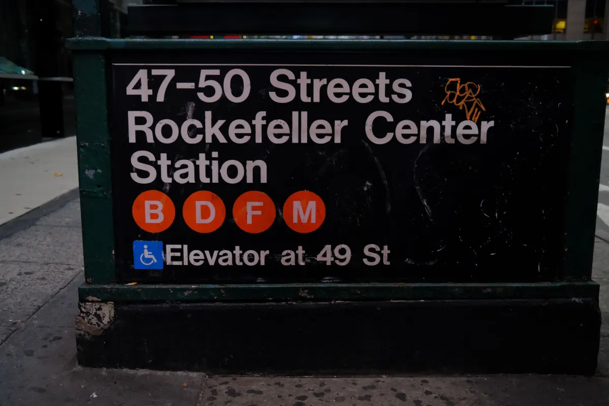 A subway entrance sign reading 47-50 Streets Rockefeller Center Station.