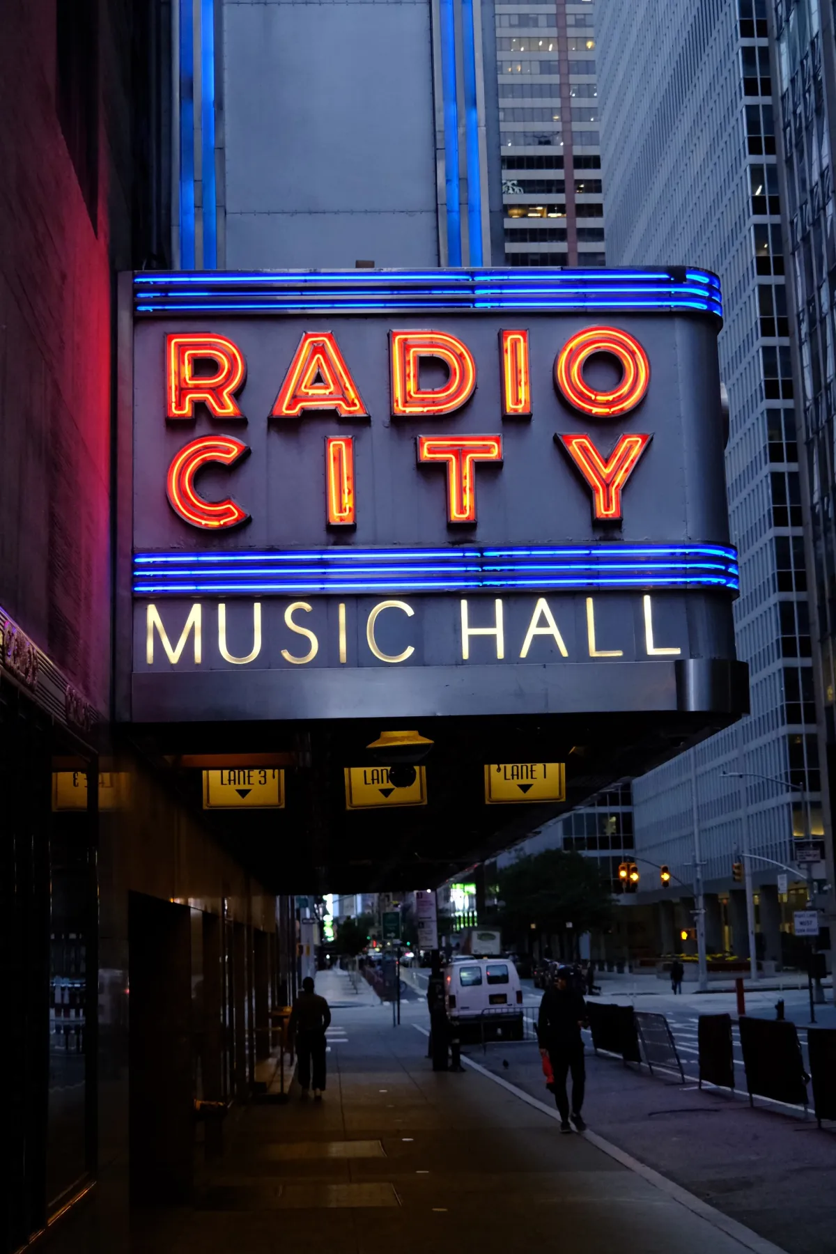The neon marquee of Radio City Music Hall lit up at night.