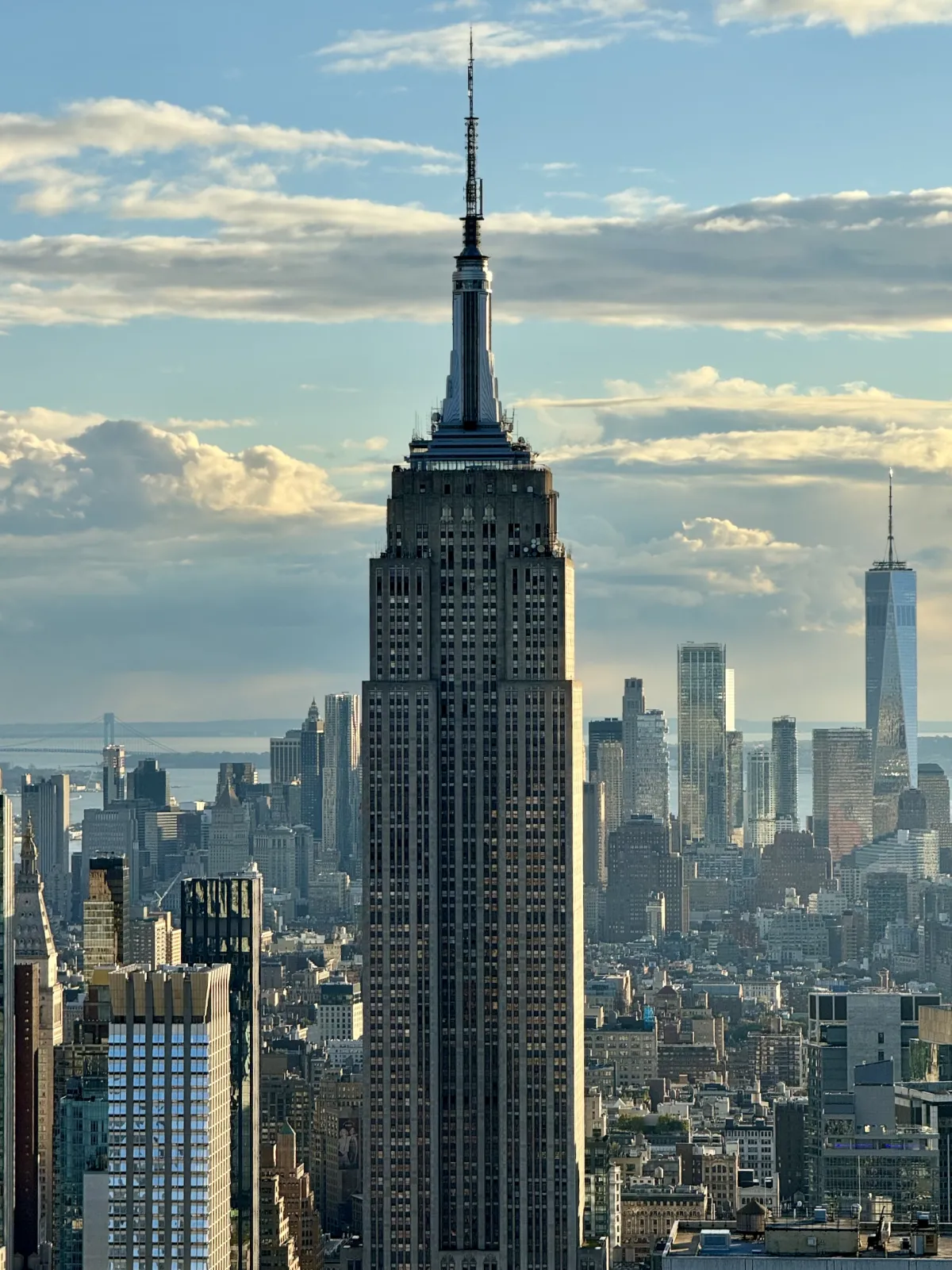 The Empire State Building rising above the Manhattan skyline, with One World Trade Center behind.