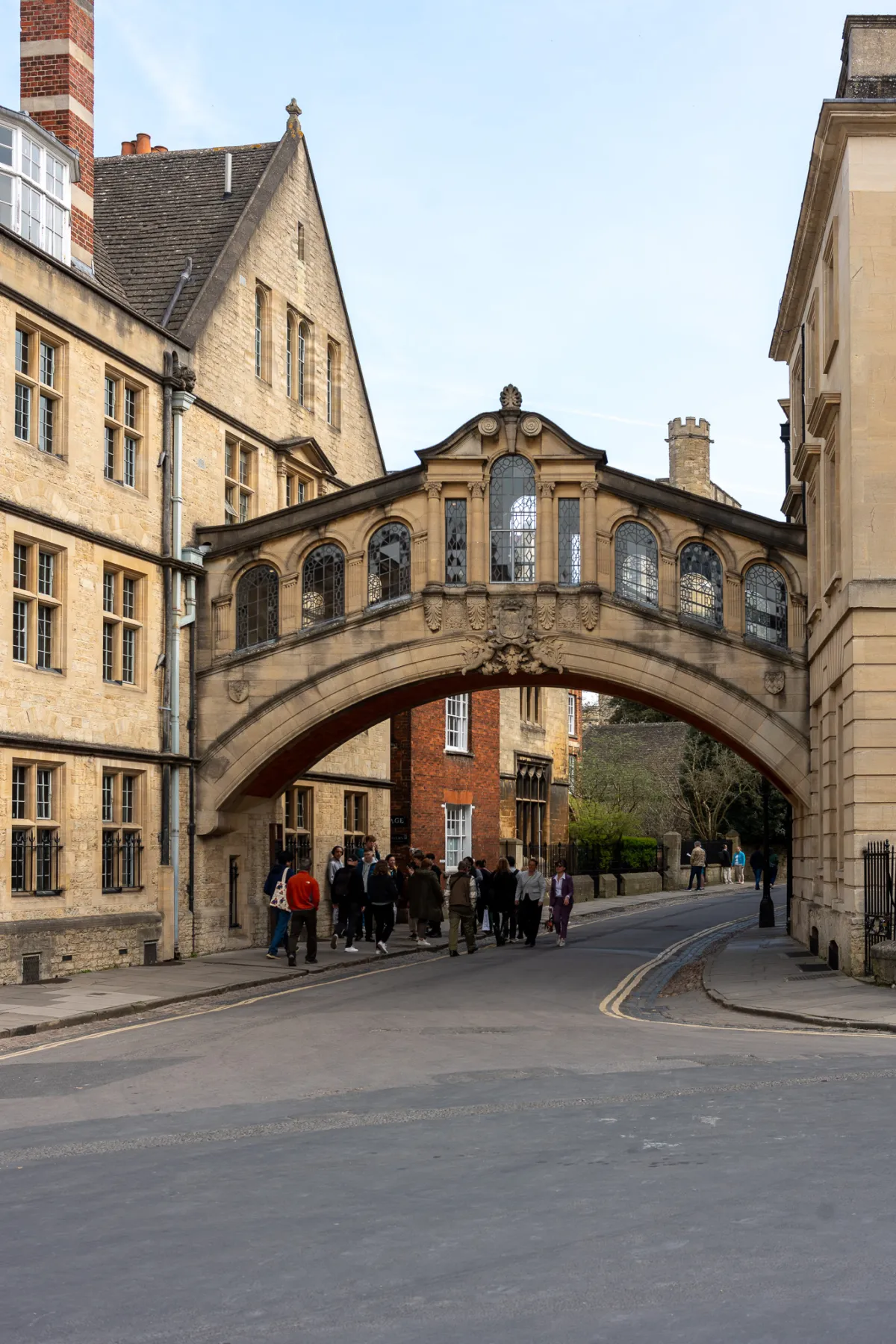 The Bridge of Sighs spanning a street between college buildings, with people walking beneath.
