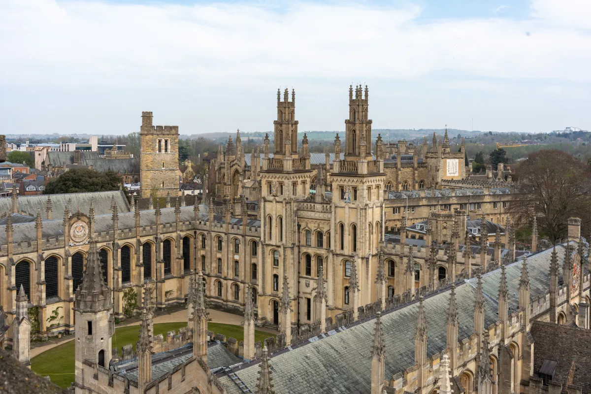 Spires, pinnacles and a quadrangle of college buildings seen from a rooftop.