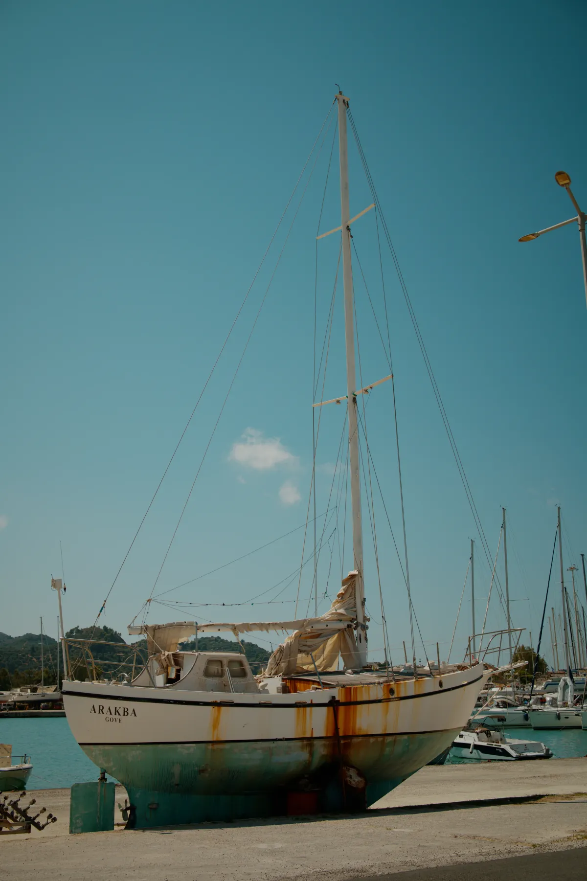 A yacht propped up on the quayside of a marina.