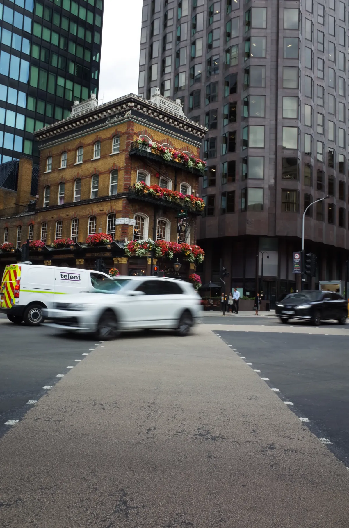 A road junction with a pub in the background.
