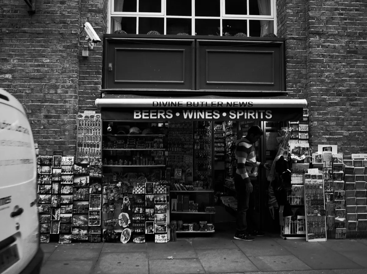 A shop front with various items crowded into the window.