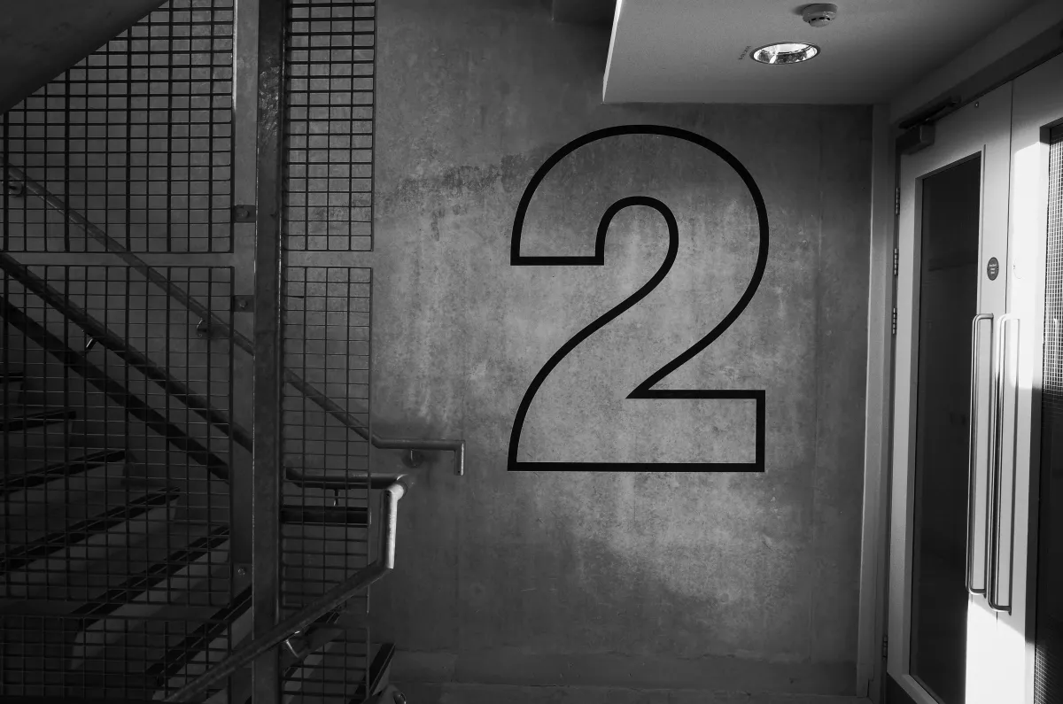 A stairwell with a number 2 decal on the wall.